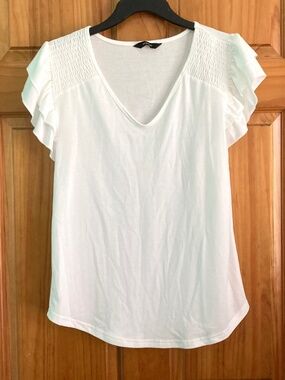 Women’s size small Dokotoo white V-neck blouse with shirring and ruffled sleeves